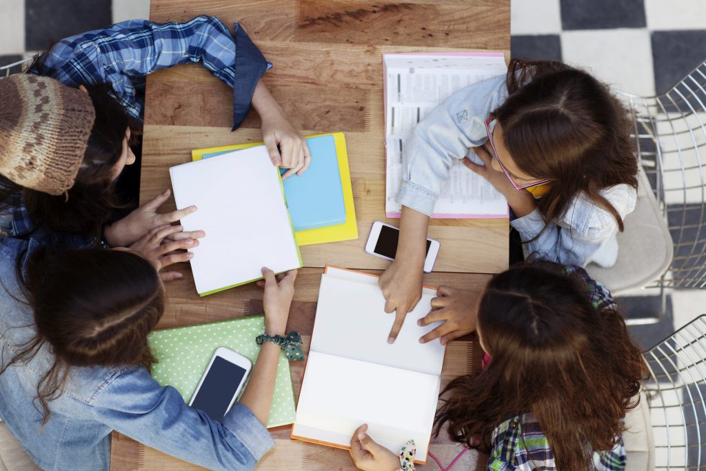 Students in a classroom using School+ LMS on laptops